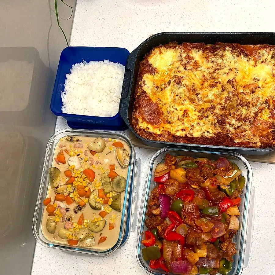 Golden lasagne, vegetable stew and stir-fry prepped in containers