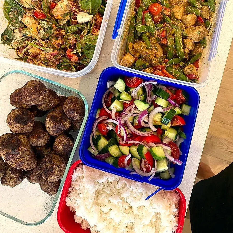 Vibrant chicken salad, meatballs and greek salad in containers